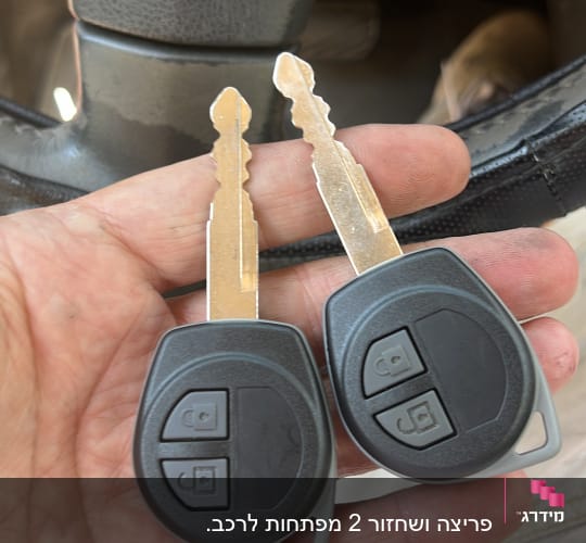 שני מפתחות רכב עם שלט ביד אדם